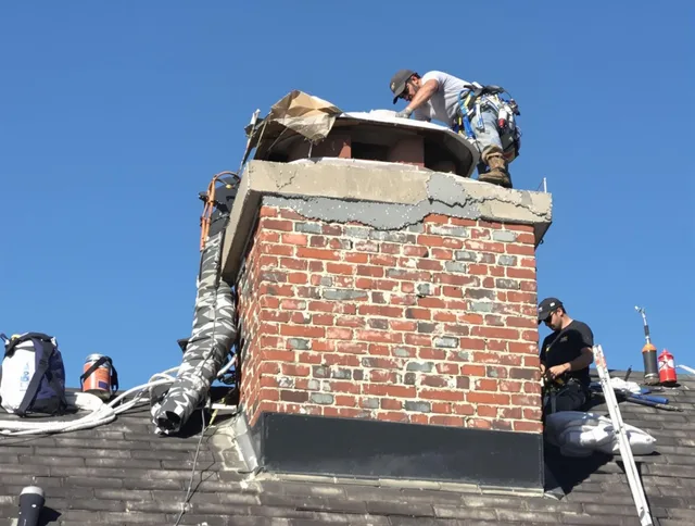 Manhattan Beach Chimney Sweep installing a custom chimney crown in Manhattan Beach, CA